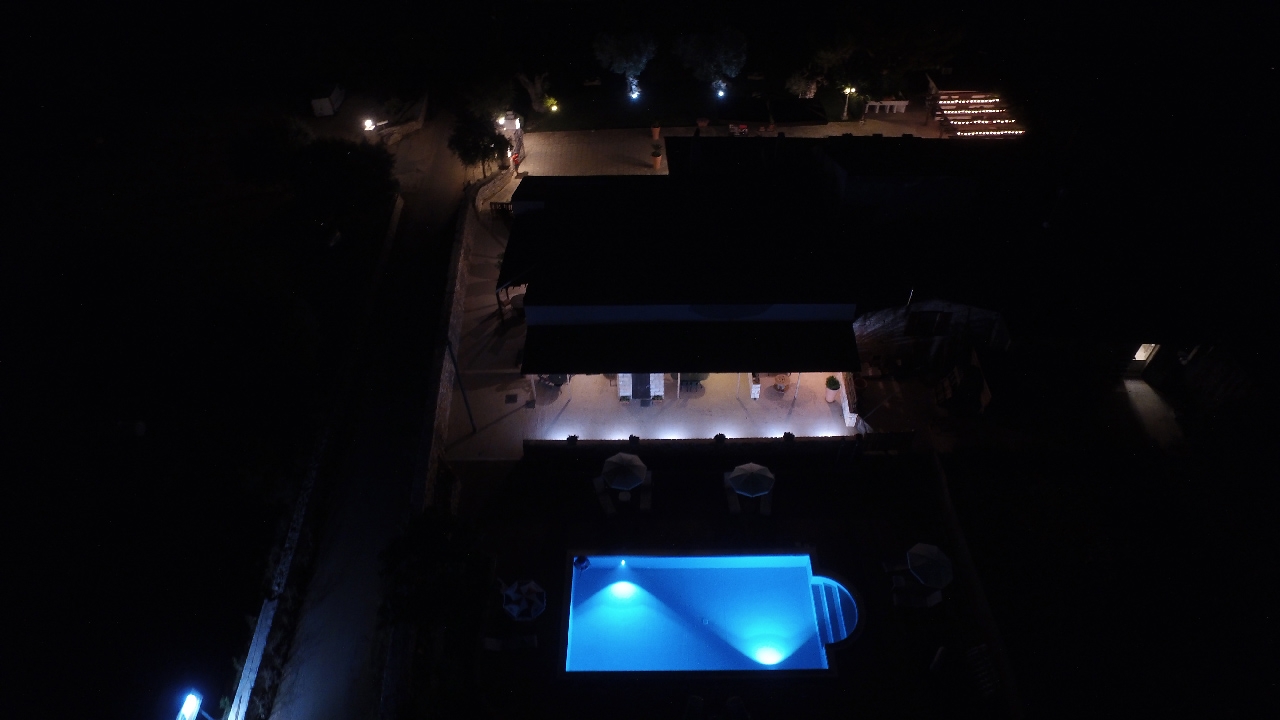 farmhouse with swimming pool at night